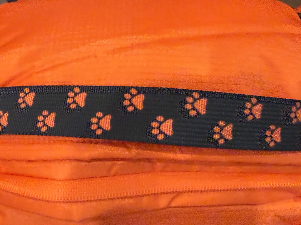 Paw-print strap and zip detail